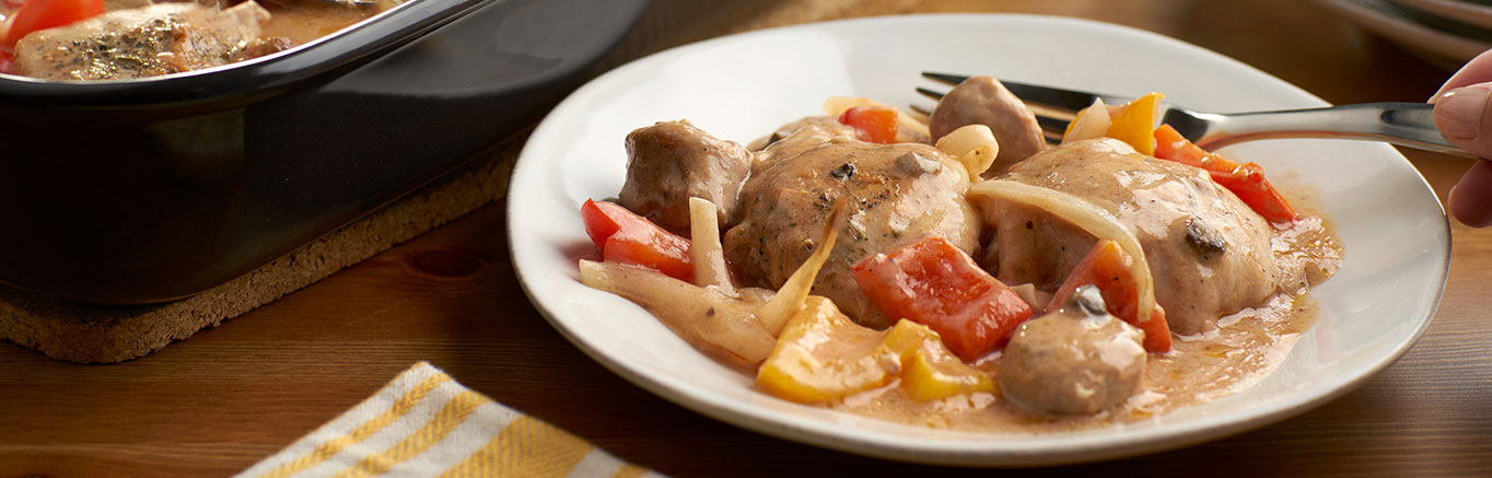 An image of prepared One Dish Creamy Chicken & Sausage Bake made with chicken, pork sausage, onion, peppers, Campbell's® Condensed Cream of Mushroom Soup and Swanson® Natural Goodness® Chicken Broth.