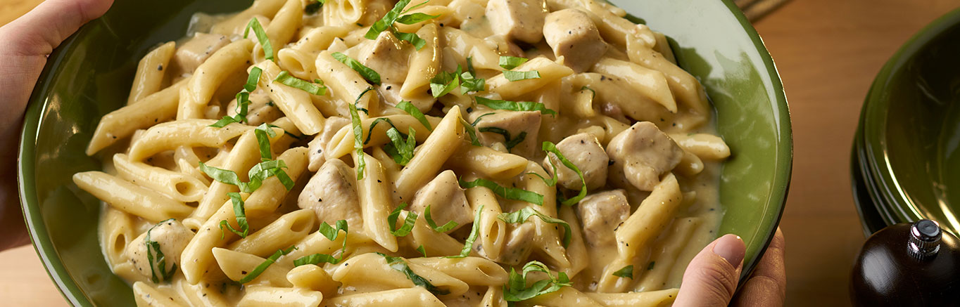 An image of prepared One Pot Chicken Parmesan Peppercorn Pasta made with chicken, Campbell's® Condensed Cream of Chicken Soup, Swanson® Chicken Broth, penne pasta, Parmesan cheese and basil.