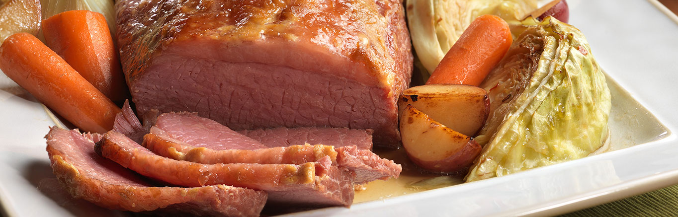 An image of prepared Oven Braised Corned Beef & Cabbage made with Swanson® 50% Less Sodium Beef Broth or Unsalted Beef Stock, beef brisket, onion, carrot, red potato and green cabbage.