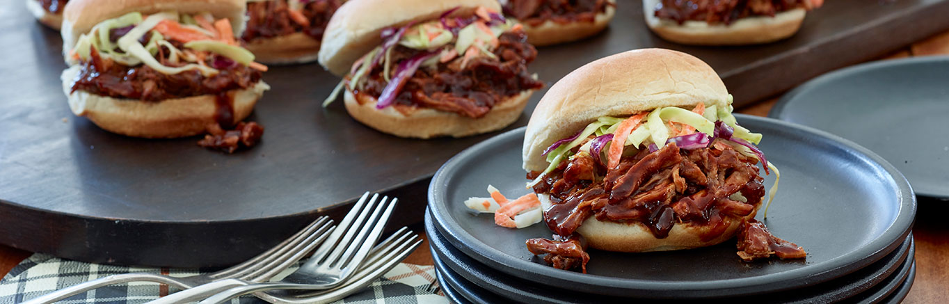 An image of prepared Pulled Pork Sliders made with pork shoulder, onion, Swanson® Chicken Stock, ketchup, cider vinegar, molasses and Pepperidge Farm® White Slider Buns.