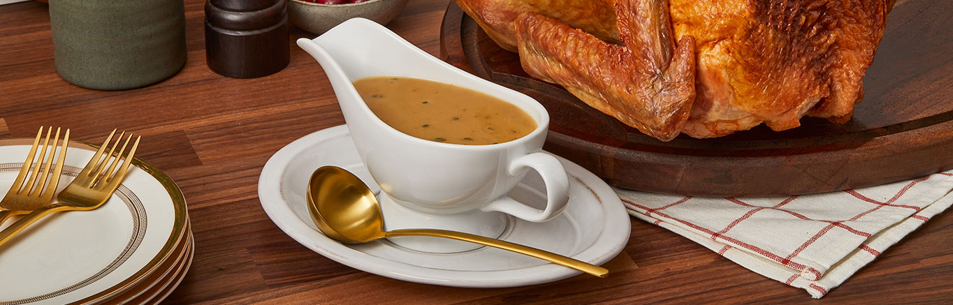 An image of prepared Quick Turkey Gravy made with turkey pan drippings, onion, flour, Swanson® Chicken Broth and thyme.