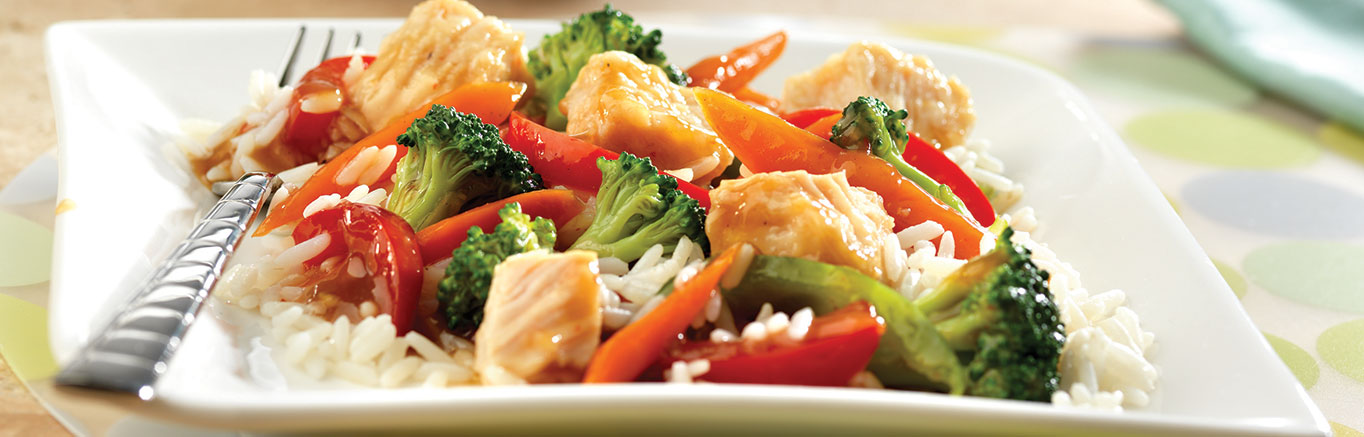 An image of prepared Quick Chicken Stir-Fry made with Swanson® Chicken Broth or Chicken Stock, soy sauce, vegetables, Swanson® Premium White Chunk Chicken and rice.