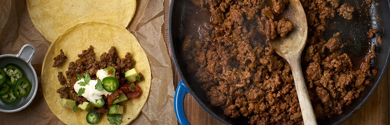 An image of prepared Restaurant-Style Beef Tacos made with onion, ground beef, chili powder, cumin, Swanson® Beef Stock, lime juices and corn tortillas.