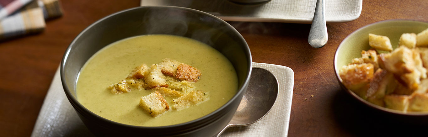 An image of prepared Roasted Asparagus Soup made with asparagus, sweet onion, garlic, Swanson® Vegetable Broth and cream.
