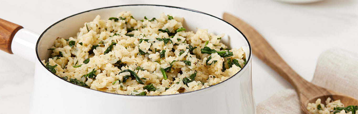An image of prepared Simmered Italian Rice made with Swanson® Chicken Broth, rice, spinach and Parmesan cheese.