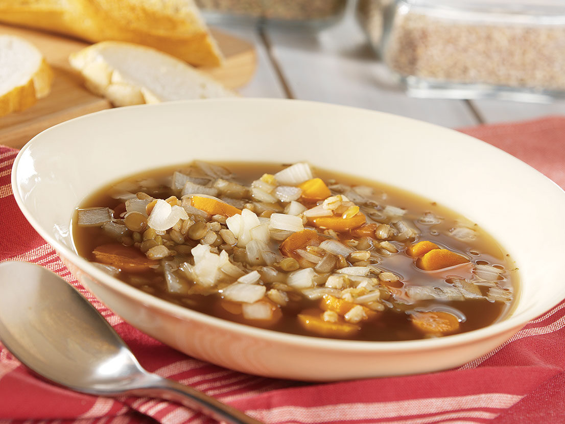 An image of prepared Slow Cooker Barley & Lentil Soup made with Swanson® Beef Broth, garlic, carrots, onion, lentils and barley.