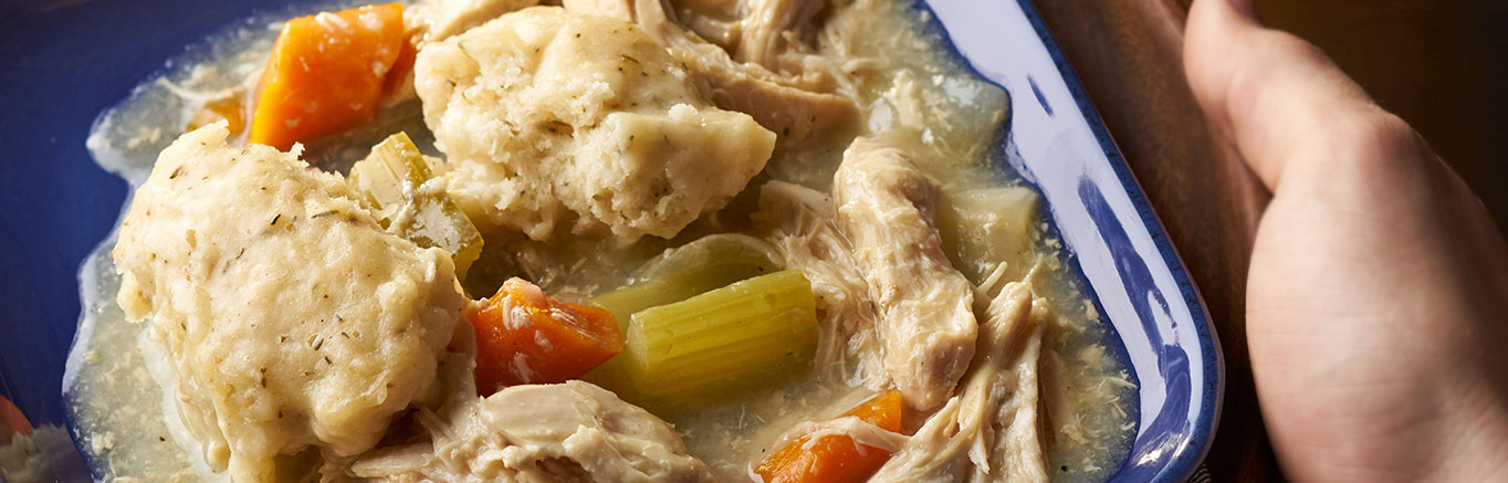 An image of prepared Slow Cooker Chicken & Herb Dumplings made with chicken, carrots, celery, onion, Swanson® Chicken Broth and dumplings.