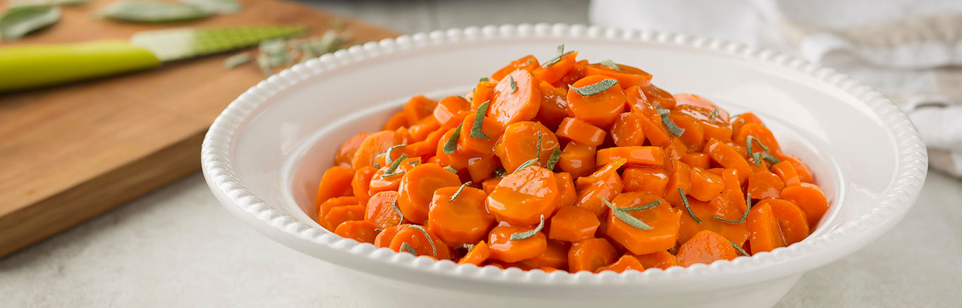 An image of prepared Slow Cooker Orange-Glazed Carrots made with carrots, Swanson® Chicken Broth, brown sugar, orange marmalade, butter and sage.