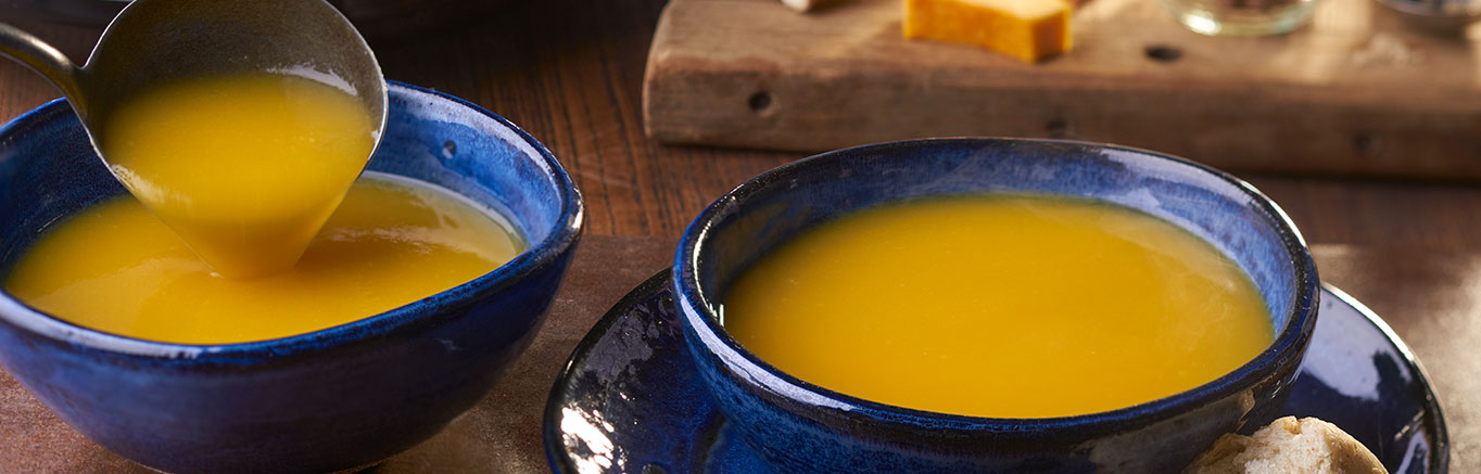 An image of prepared Slow Cooker Winter Squash Soup made with Swanson® Chicken Broth, ginger, butternut squash, acorn squash and sweet onion.