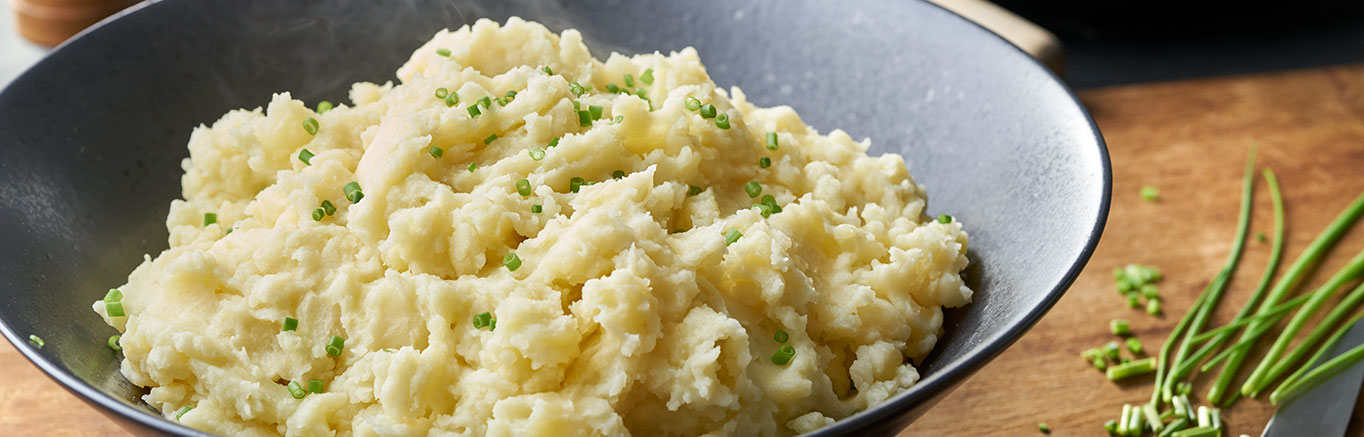 An image of prepared Slow Cooker Yukon Gold Creamy Mashed Potatoes made with Yukon Gold potatoes, Swanson® Chicken Broth, light cream and butter.
