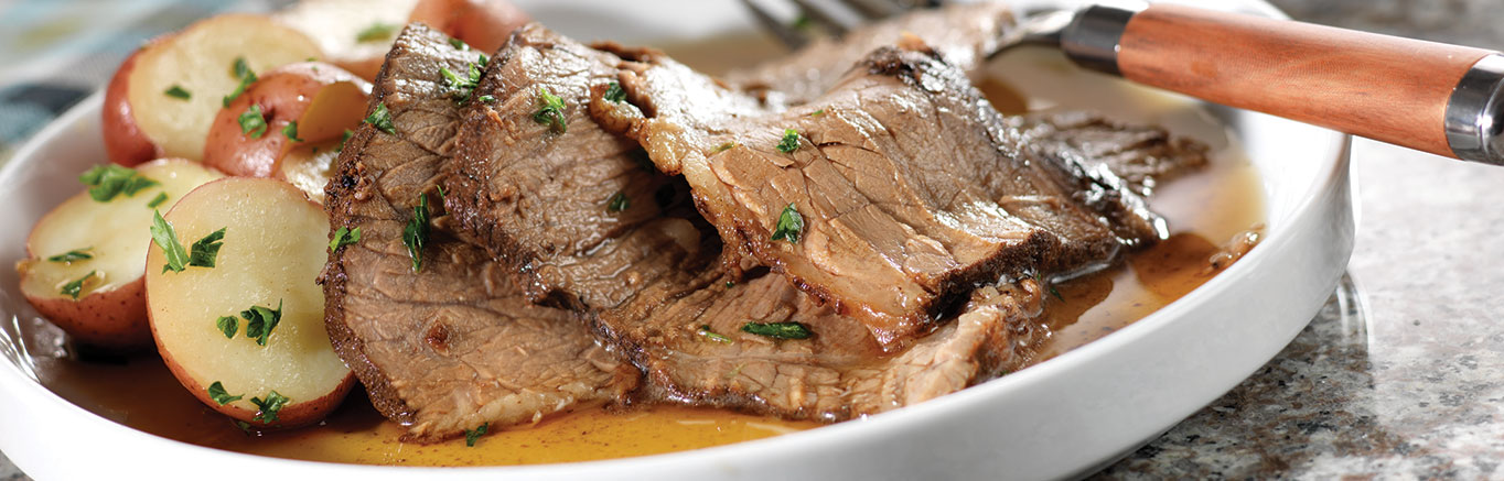 An image of prepared Spiced Pot Roast made with cloves, allspice, cinnamon, beef chuck roast, Swanson® Beef Stock, stout or dark beer and parsley.