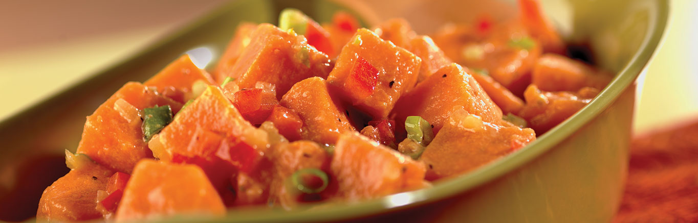 An image of prepared Sweet Potato Salad made with sweet potatoes or yams, Swanson® Vegetable Broth, green onion and red bell pepper.