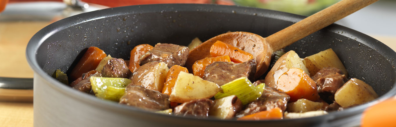 An image of prepared Vegetable Beef Stew made with beef, Swanson® Vegetable Broth, carrots, potatoes and celery.