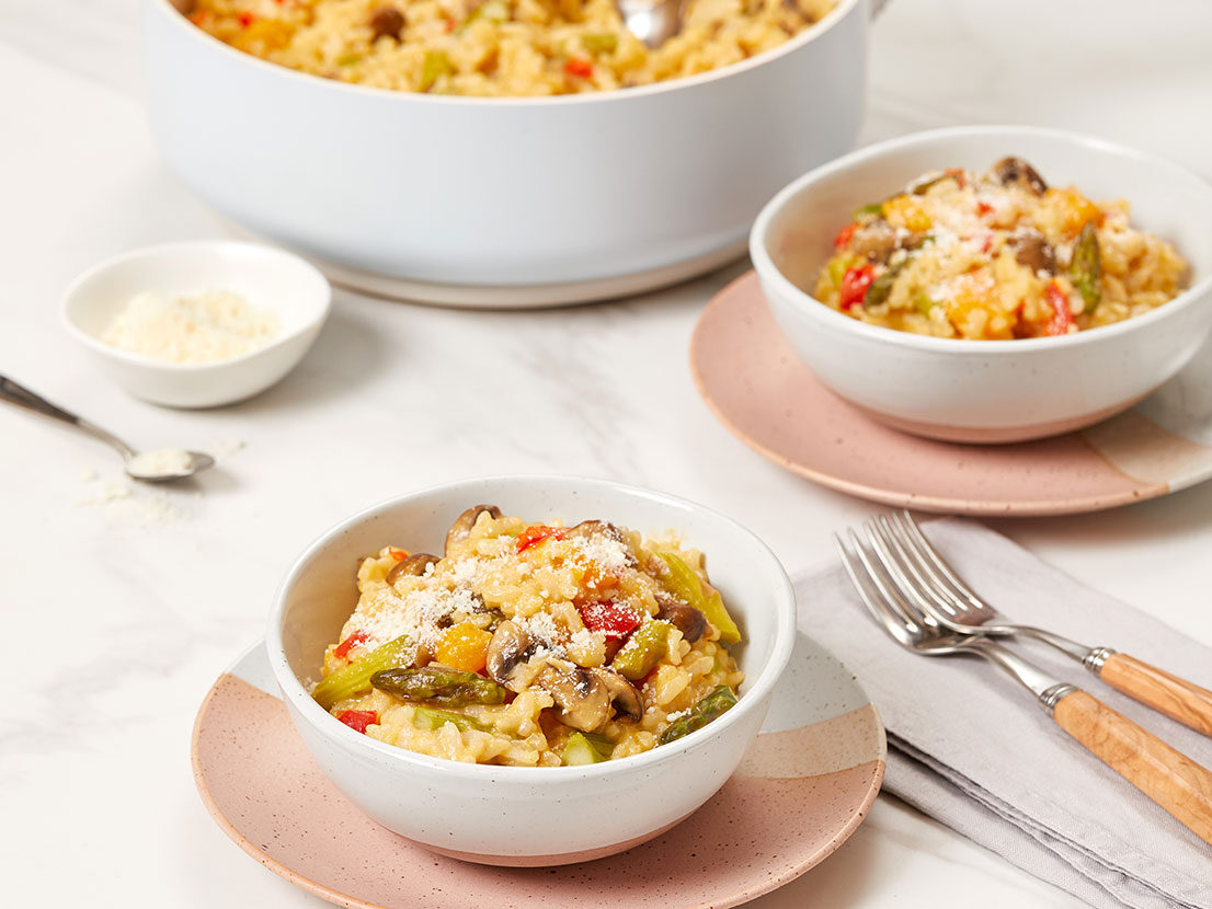 An image of prepared Vegetable Risotto made with red bell pepper, butternut squash, mushrooms, arborio rice, white wine, Swanson® Vegetable Stock, asparagus and Parmesan.