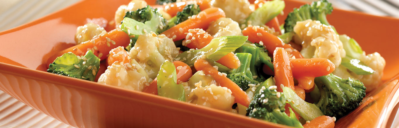 An image of prepared Vegetable Stir-Fry made with Swanson® Chicken Broth, broccoli, cauliflower, baby carrots, celery, ginger and garlic.