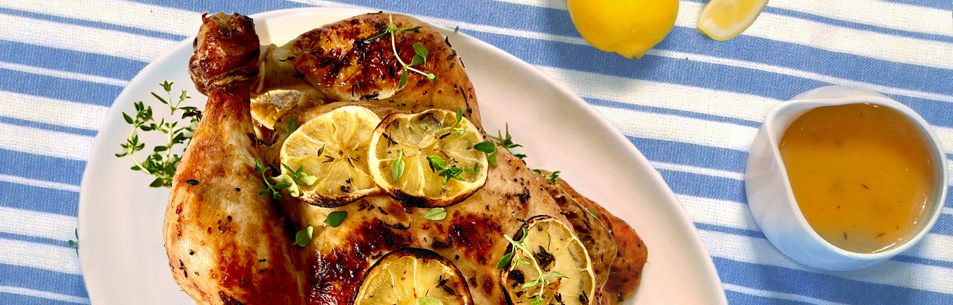 Image of prepared Lemon-Thyme Roasted Chicken with Lemon Curd Sauce made with lemon, a whole chicken, lemon curd, thyme and Swanson® Chicken Broth.