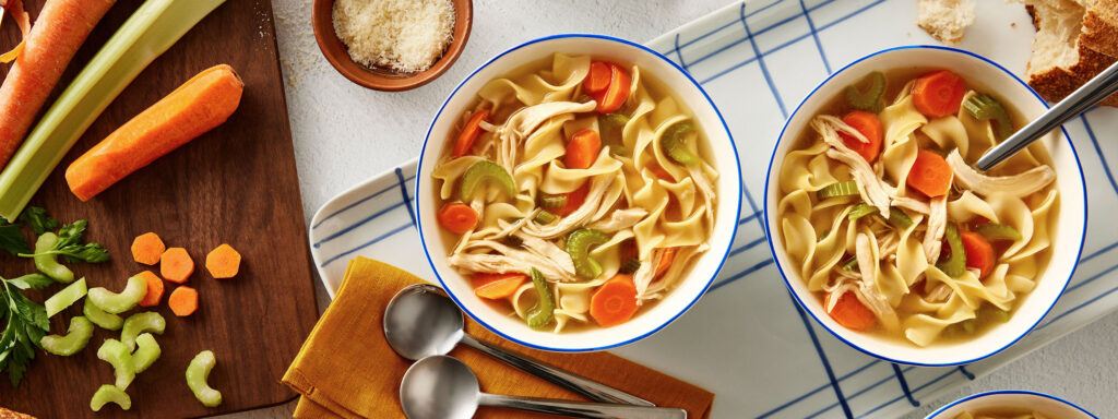 An image of prepared Sensational Chicken Noodle Soup made with Swanson® Chicken Broth, carrot, celery, egg noodles and cooked chicken or turkey.