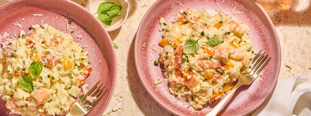 An image of prepared Shrimp & Lobster Risotto made with arborio rice, white wine, Swanson® Chicken Broth or Chicken Stock, shrimp, lobster, Parmesan, mascarpone cheese and chives.