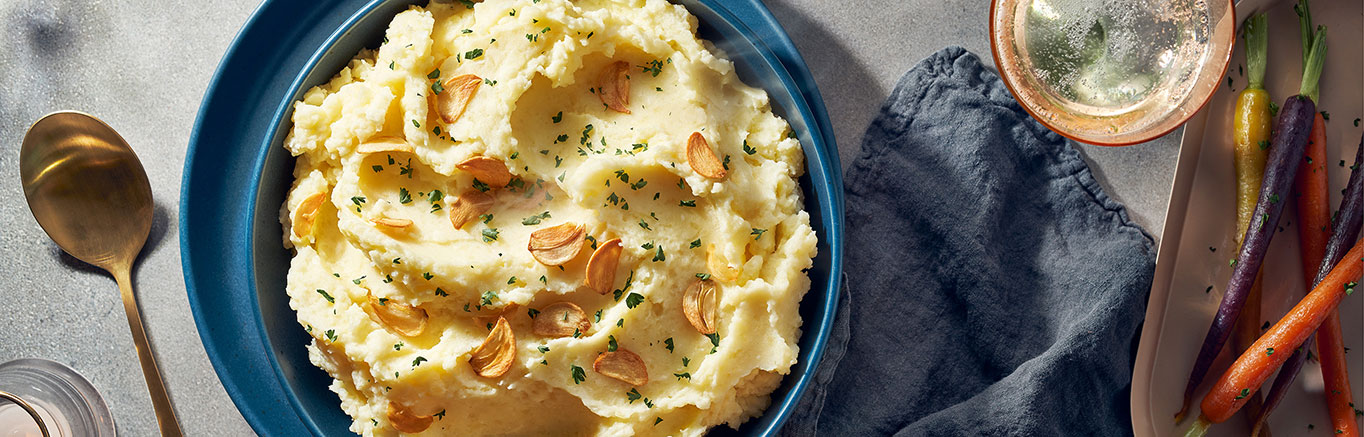 An image of prepared Garlic Parmesan Mashed Potatoes made with Swanson® Chicken Broth, potatoes, garlic, light cream or half and half, butter and Parmesan cheese.