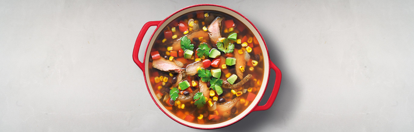 An image of prepared Spicy Steak Soup with Beans & Corn made with beef flank steak, onion, garlic, Swanson® Spicy Beef Broth, black beans and corn.