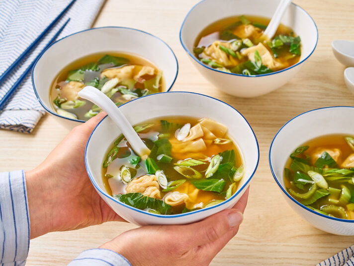An image of prepared 10-Minute Wonton Ramen Soup made with Swanson® Ramen Chicken Broth, dumplings or wontons, baby bok choy and green onion.