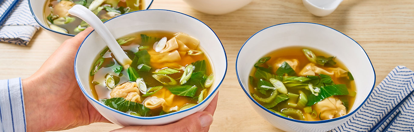 An image of prepared 10-Minute Wonton Ramen Soup made with Swanson® Ramen Chicken Broth, dumplings or wontons, baby bok choy and green onion.