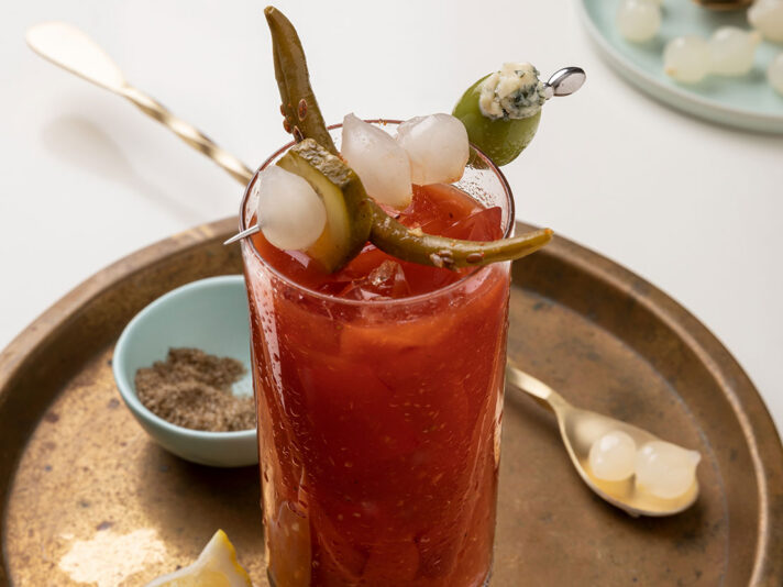 An image of prepared Ultimate Bloody Mary made with V8® 100% Vegetable Juice, vodka, olive juice, lemon juice, horseradish, Worcestershire, garlic powder, onion powder, celery salt and seafood seasoning.