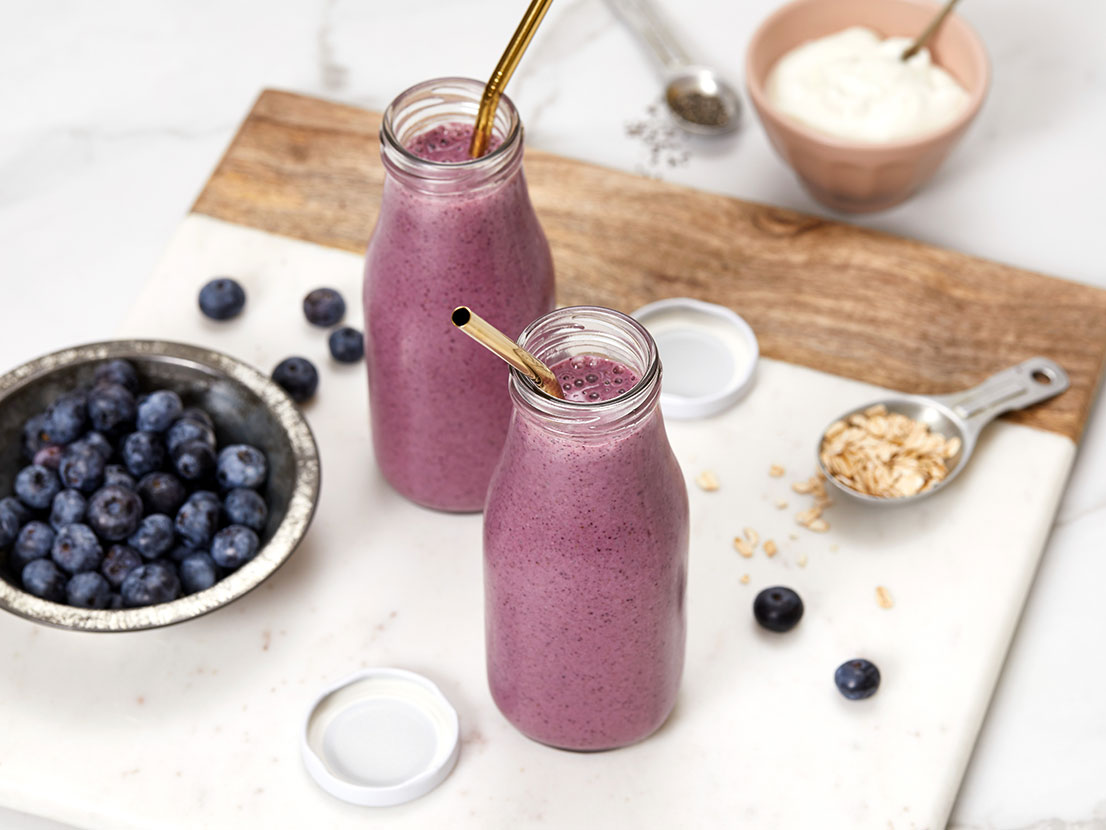 An image of prepared Antioxidant Berry Smoothie made with V8® Strawberry Banana 100% Fruit and Vegetable Juice, banana, blueberries, yogurt, oats, almond butter and Chia seeds.