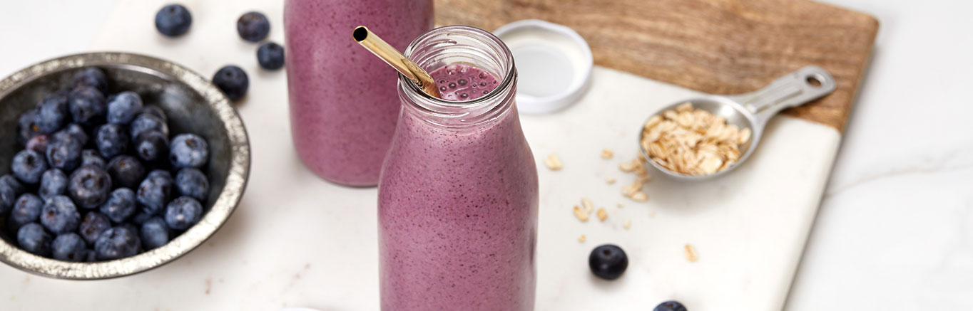 An image of prepared Antioxidant Berry Smoothie made with V8® Strawberry Banana 100% Fruit and Vegetable Juice, banana, blueberries, yogurt, oats, almond butter and Chia seeds.