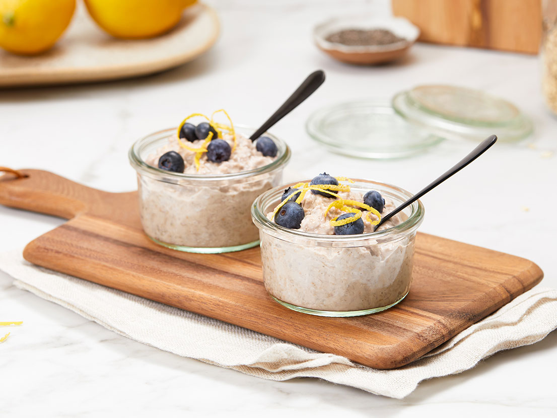 An image of prepared Blueberry Lemon Overnight Oats made with oats, V8® Pomegranate Blueberry 100% Fruit and Vegetable Juice, yogurt, lemon zest and chia seeds.