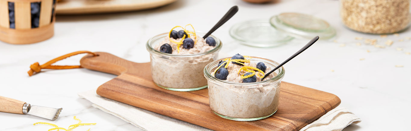 An image of prepared Blueberry Lemon Overnight Oats made with oats, V8® Pomegranate Blueberry 100% Fruit and Vegetable Juice, yogurt, lemon zest and chia seeds.