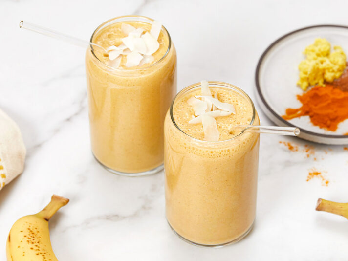 An image of prepared Plant-Based Golden Milk Smoothie made with V8® Peach Mango 100% Fruit and Vegetable Juice, oats, coconut milk and banana.