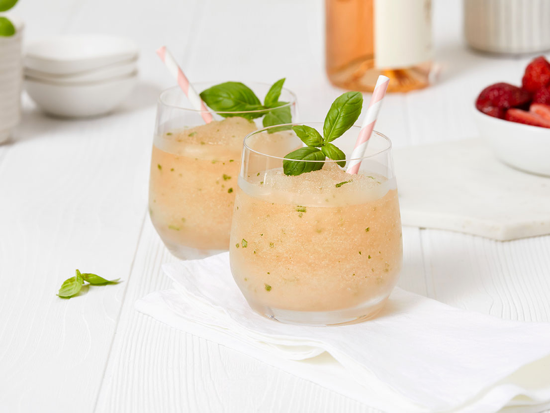 An image of prepared Strawberry Frosé made with V8® Energy Diet Strawberry Lemonade, dry rosé wine, basil and strawberries.