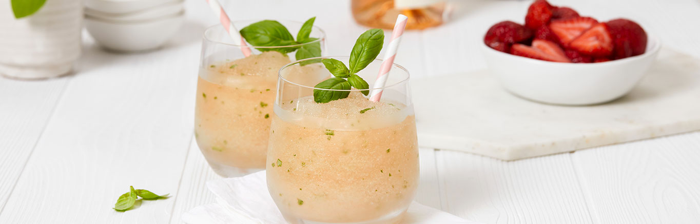 An image of prepared Strawberry Frosé made with V8® Energy Diet Strawberry Lemonade, dry rosé wine, basil and strawberries.