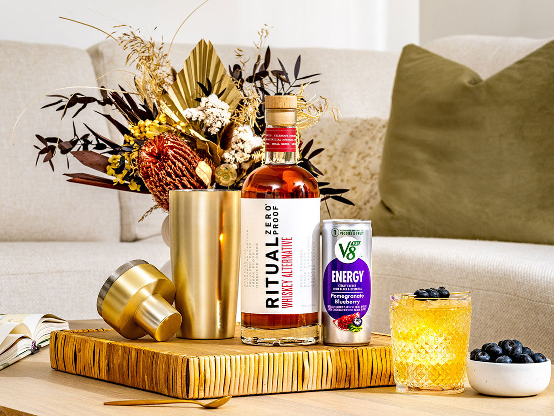 An image of prepared Non-Alc Smashing Sunset made with V8 Energy® Pomegranate Blueberry, Ritual Zero Proof Whiskey Alternative, lemon juice and pure maple syrup.