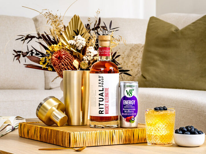 An image of prepared Non-Alc Smashing Sunset made with V8 Energy® Pomegranate Blueberry, Ritual Zero Proof Whiskey Alternative, lemon juice and pure maple syrup.