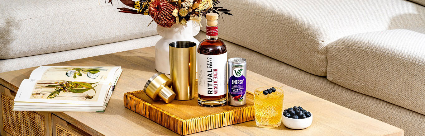 An image of prepared Non-Alc Smashing Sunset made with V8 Energy® Pomegranate Blueberry, Ritual Zero Proof Whiskey Alternative, lemon juice and pure maple syrup.