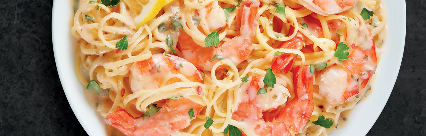 An image of prepared Shrimp Scampi made with shrimp, linguine, Parmesan cheese, lemon and Campbell's® Classic Scampi Cooking Sauce.