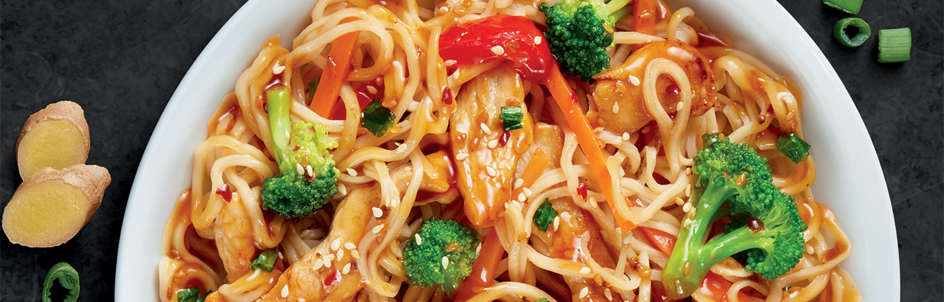 An image of prepared Sesame Garlic Chicken Noodle Bowl made with chicken, broccoli, carrot, bell pepper and Campbell's® Sesame Garlic Cooking Sauce.