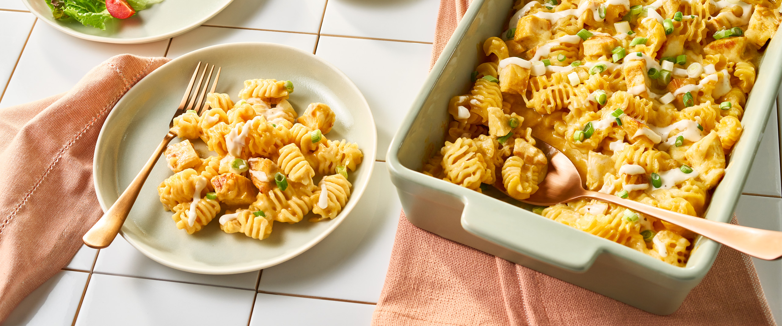 An image of prepared Creamy Buffalo Chicken Mac & Cheese made with radiatore pasta, Campbell's® Condensed Spicy Buffalo-Style Cream of Chicken Soup, chicken, Monterey Jack cheese and green onion.
