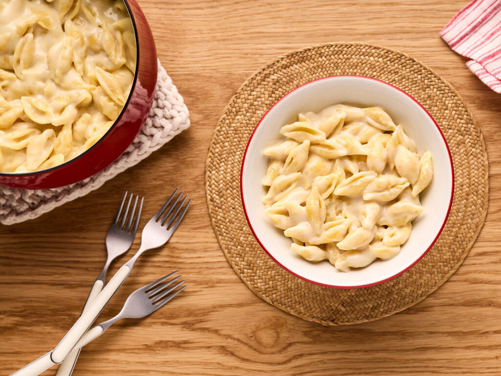 An image of prepared Creamy White Cheddar Mac & Cheese made with medium shell shaped pasta, Campbell's® Condensed White Cheddar Cheese Soup, white Cheddar cheese and milk.