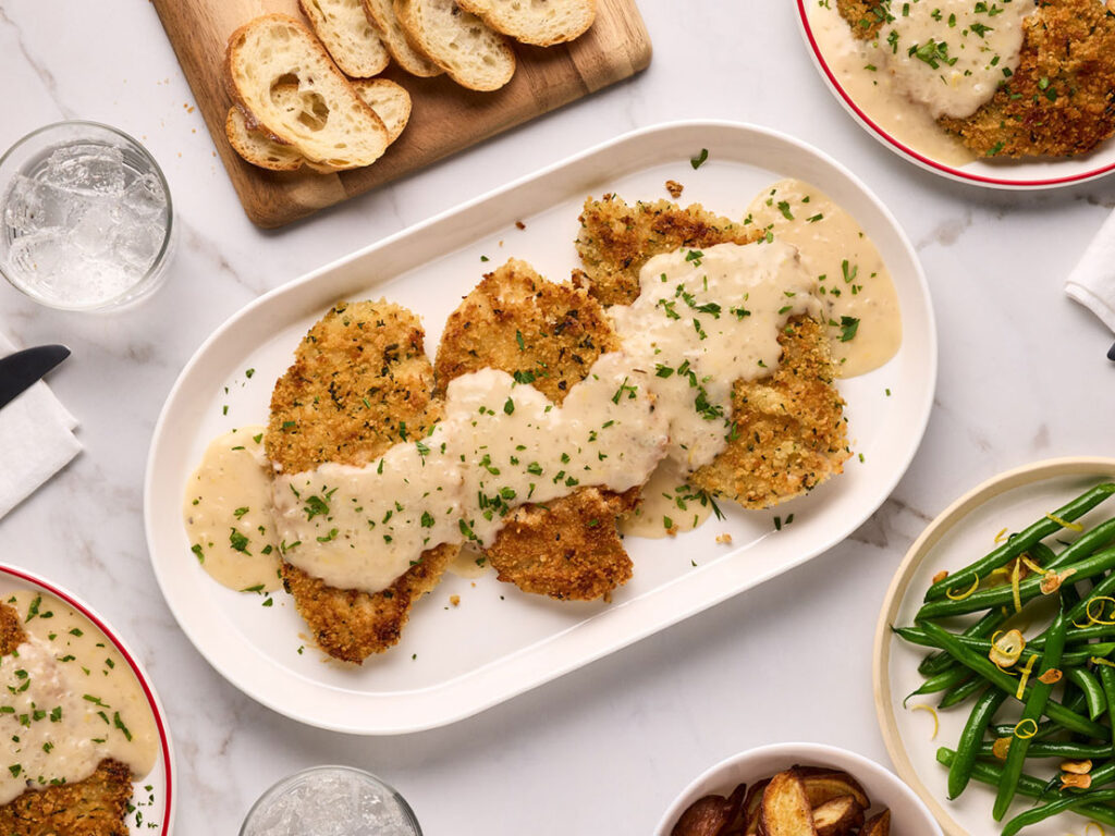 An image of prepared Crispy Garlic Parm Chicken made with panko, Campbell's® Condensed Garlic Parmesan with Herbs Soup, chicken, white wine and lemon zest.